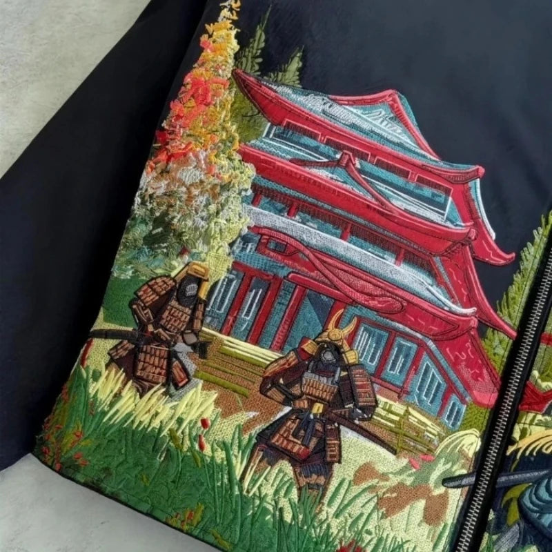 Embroidered design on a fabric with samurai warriors and a traditional building.